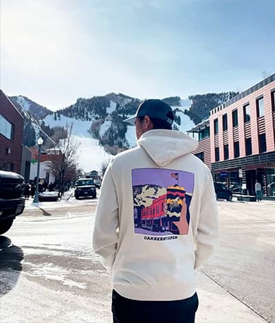 A person standing in the snow wearing OAKBERRY Sweatshirt